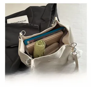 Detail view of woven tote bag interior showing large capacity for umbrella and notebook