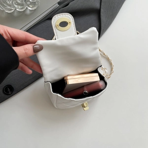 White quilted crossbody chain bag with gold lock showing mini interior storage