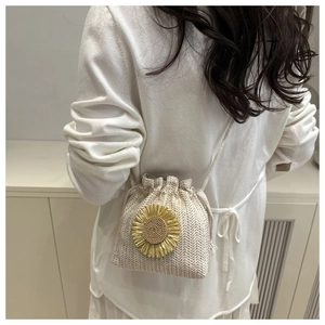 Dettaglio di un secchiello in paglia con fibbia a girasole dorata e coulisse
