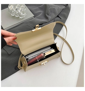 Top view of beige leather bag interior showing space for smartphone and lipstick