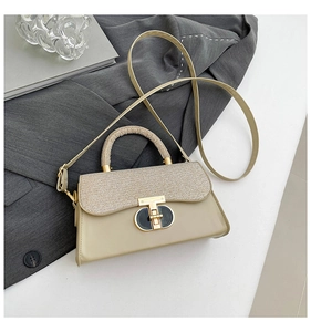 Detail of beige leather crossbody bag with woven flap and golden T-shaped metal lock