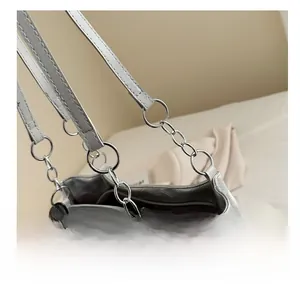 Detail of silver tote bag showing metal chain strap and secure zipper closure