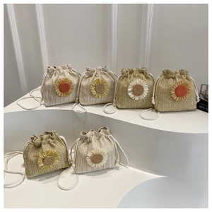 Detailed display of straw bucket bags with sunflower accents and cotton rope straps