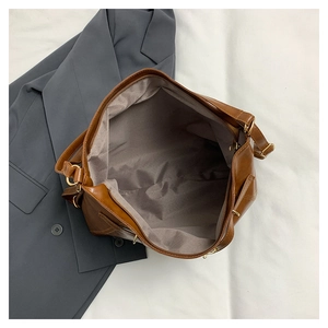 Top view of large brown tote bag showing gray fabric lining and spacious interior