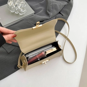Beige leather crossbody bag with gold buckle showing spacious interior for essentials