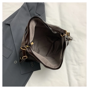 Macro shot showing the spacious interior lining and zipper of the dark brown tote bag