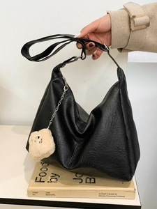 Black litchi-grain leather tote bag with silver chain and cute teddy bear charm detail