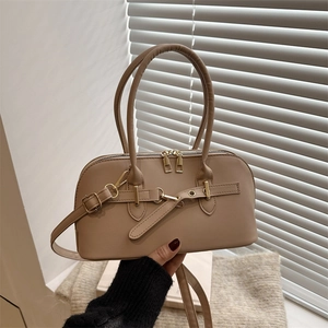 Detail showing the khaki textured PU leather bowling bag with gold zipper and dual handles