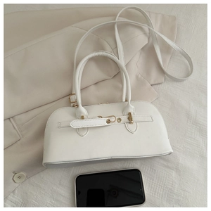 Top view of white Boston handbag with gold hardware on white textured fabric