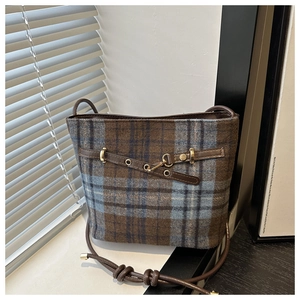 Detailed view of vintage blue plaid wool bucket bag with premium leather straps