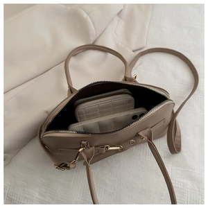 Top view of khaki commuter bag interior showing storage space for phone and wallet
