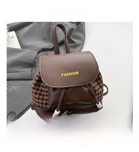 Detail of vintage plaid backpack with drawstring closure and fashion letter printing