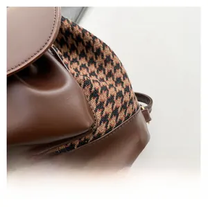 Detail of leopard print fabric and premium brown leather texture on a fashion backpack