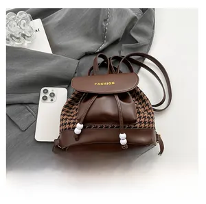 Detail of vintage mini houndstooth backpack with drawstring closure and leather flap