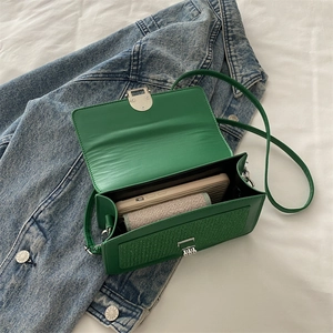 Green PU leather crossbody bag with woven texture detail and silver metal lock closure