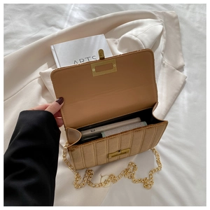 Internal view of brown velvet crossbody bag showing storage for phone and tissues