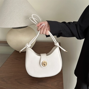 Chic white half-moon saddle bag with golden metal lock and stylish knotted shoulder strap