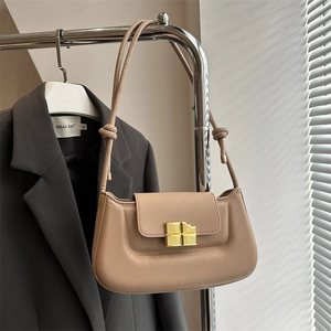 Chic beige baguette leather shoulder bag with gold square clasp and knotted strap details
