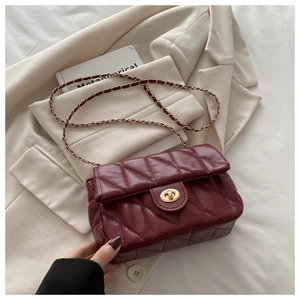 Close-up of wine red quilted shoulder bag featuring gold twist lock and chain strap