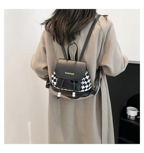 Detail of checkered houndstooth backpack with drawstring and yellow fashion logo