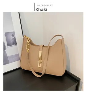 Detail of khaki leather shoulder bag featuring gold chain and metallic buckle lock