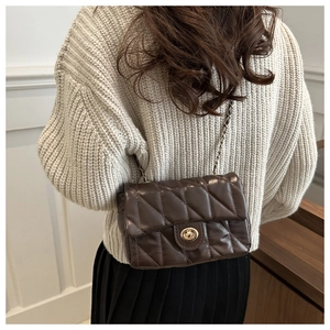 Quilted dark brown chain bag shown from a back perspective with gold turn-lock buckle