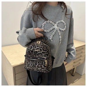 Mini leopard print backpack for women featuring gold zippers and adjustable straps