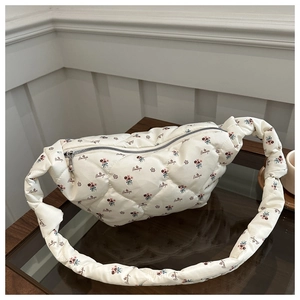 Close-up of quilted nylon dumpling bag featuring floral prints and Beautiful lettering