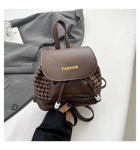 Detail of vintage houndstooth backpack showing faux leather trim and drawstring with beads