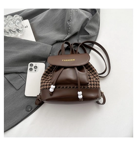 Detail of vintage houndstooth backpack with drawstring closure and FASHION logo