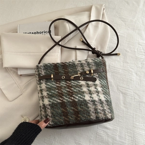 Vintage green plaid tweed bucket bag with leather strap and golden metal buckle details