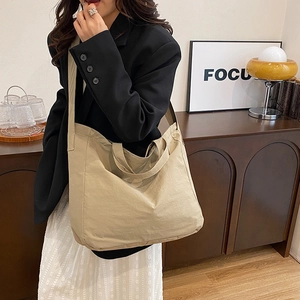 Minimalist beige canvas tote bag with large capacity and wide shoulder strap for women