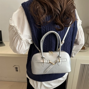 Silver metallic leather half-moon handbag with gold buckle and adjustable crossbody strap