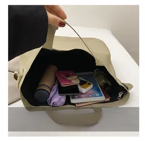 Detail shot of the khaki canvas tote bag interior showing large capacity for essentials