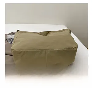 Detail shot of the durable reinforced base on this large capacity khaki tote bag