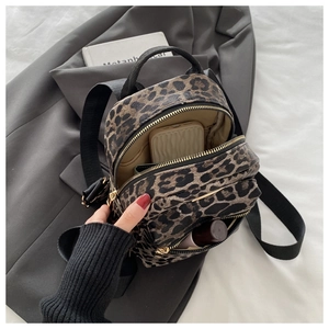 Top view of mini leopard print backpack showing interior storage for phone and cosmetics