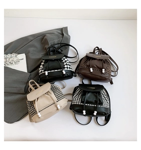Detail of mini houndstooth and PU leather backpacks with drawstring closure and fashion text