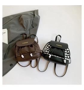 Detail of mini backpacks with houndstooth and checkerboard patterns and gold lettering