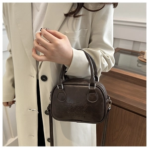 Detail of dark brown retro tote bag with lucky OHIO embossed text on textured leather