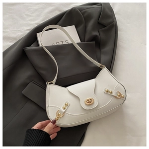 Detail of white leather crescent bag with golden twist lock and vintage rivet hardware