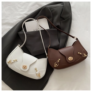 Detail of vintage rivet shoulder bags with gold buckle lock and premium leather texture