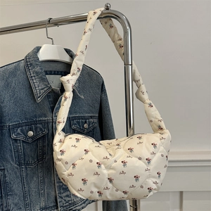 Cream quilted nylon crossbody bag with floral pattern and knotted strap detail