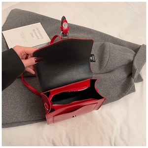 Detail of red wax leather bag interior featuring a functional zipper pocket and lining