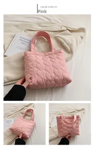 Detail of pink heart-quilted fabric tote bag with soft polyester texture and stitching