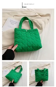 Detailed view of green puffer tote featuring heart-shaped quilting and gold snap button