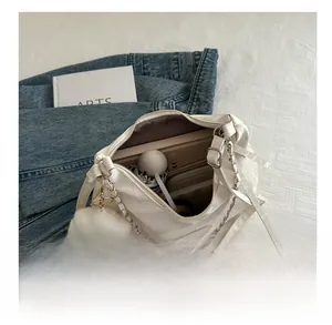 Large capacity shoulder bag interior showing storage for umbrella and books with plush charm