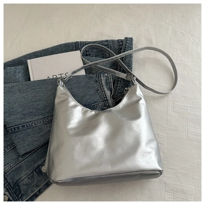 Detailed top view of a silver metallic hobo bag featuring an adjustable strap and zip closure