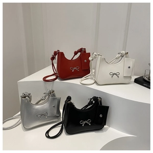 French design patent leather underarm bags with metallic bows in red, white, silver, and black