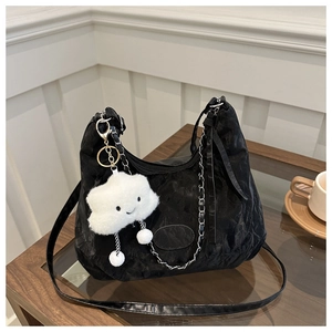 Detail of black pleated nylon shoulder bag with silver chain and plush cloud charm