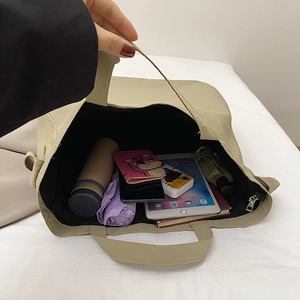 Spacious khaki canvas tote bag showing large capacity for umbrella and tablet
